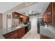 Kitchen features granite countertops, stainless steel appliances, tile backsplash, and wood cabinets at 2995 E Sunset Rd # 134, Las Vegas, NV 89120