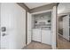 Laundry room features washer, dryer, and storage shelves at 2995 E Sunset Rd # 134, Las Vegas, NV 89120