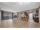 Open living room with fireplace, tile flooring, and sliding glass doors to the outside patio at 2995 E Sunset Rd # 134, Las Vegas, NV 89120