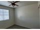 Bright bedroom featuring a ceiling fan, window with blinds, and gray laminate flooring at 3021 New Journey Way, North Las Vegas, NV 89031