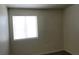Bedroom featuring a window with blinds and gray laminate flooring at 3021 New Journey Way, North Las Vegas, NV 89031