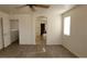 A bedroom featuring vinyl plank flooring, ceiling fan and view to the en-suite at 3021 New Journey Way, North Las Vegas, NV 89031