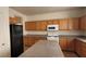 A kitchen featuring wooden cabinets, modern appliances, and ample countertop space at 3021 New Journey Way, North Las Vegas, NV 89031