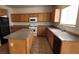 Well-equipped kitchen with island, wooden cabinets, and modern appliances at 3021 New Journey Way, North Las Vegas, NV 89031