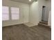 Modern living room with laminate floors and natural light from two windows at 3021 New Journey Way, North Las Vegas, NV 89031