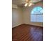A bright bedroom features an arched window, ceiling fan, and warm wood-look floors at 3125 N Buffalo Dr # 2104, Las Vegas, NV 89128
