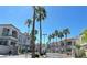 Gated community entrance featuring palm trees and well-maintained buildings under a bright blue sky at 3125 N Buffalo Dr # 2104, Las Vegas, NV 89128