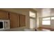 Partial view of the kitchen, showing cabinets, counters, microwave, and window to living area at 3125 N Buffalo Dr # 2104, Las Vegas, NV 89128