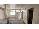 Bright living area with hardwood floors, large windows, and an adjacent bathroom at 3125 N Buffalo Dr # 2104, Las Vegas, NV 89128