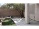 A backyard featuring a concrete patio and a patch of grass next to stucco wall at 3644 Starlight Evening St, Las Vegas, NV 89129