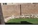 A backyard area featuring green grass and a sturdy block wall for privacy at 3644 Starlight Evening St, Las Vegas, NV 89129