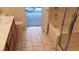 Bathroom view of vanity and bathtub with shower, tiled flooring throughout at 3644 Starlight Evening St, Las Vegas, NV 89129