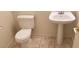 Clean bathroom featuring a pedestal sink, tile flooring, and a standard toilet at 3644 Starlight Evening St, Las Vegas, NV 89129