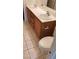 Bathroom featuring double sink vanity with wood cabinets and tile flooring at 3644 Starlight Evening St, Las Vegas, NV 89129