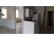 Bright kitchen with white cabinets, countertops, tile floors, and stainless steel refrigerator at 3644 Starlight Evening St, Las Vegas, NV 89129