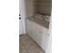 A compact laundry room features a standard washer and dryer, as well as tile flooring at 3644 Starlight Evening St, Las Vegas, NV 89129