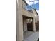 Covered patio space with a view of the fenced backyard and upper level balcony at 3644 Starlight Evening St, Las Vegas, NV 89129