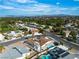 An aerial view of a neighborhood featuring lush green trees, homes with private pools, and mountain views in the background at 3647 Ottawa Cir, Las Vegas, NV 89169