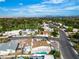 An aerial view showcasing the home's location with mature landscaping and a sprawling green golf course nearby under a clear blue sky at 3647 Ottawa Cir, Las Vegas, NV 89169