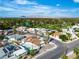 An aerial view of the neighborhood with a golf course nearby, lush green trees, and mountain views in the background at 3647 Ottawa Cir, Las Vegas, NV 89169