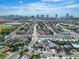 An aerial view of the neighborhood with mature trees in the distance and the Las Vegas Strip skyline in the background at 3647 Ottawa Cir, Las Vegas, NV 89169
