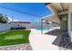 Beautiful backyard with a private pool, lush lawn, and concrete patio area perfect for entertaining at 3647 Ottawa Cir, Las Vegas, NV 89169