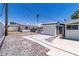 View of the backyard featuring desert landscaping and an additional structure with a gated entrance at 3647 Ottawa Cir, Las Vegas, NV 89169