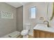 Modern bathroom featuring gray tile shower, a patterned inset, and a wood vanity with gold fixtures at 3647 Ottawa Cir, Las Vegas, NV 89169