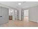 Neutral bedroom featuring gray doors, wood floors, and entries to a bathroom and closet at 3647 Ottawa Cir, Las Vegas, NV 89169
