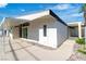 Side view of a modern white home with a covered patio, landscaped yard, and inviting entrance at 3647 Ottawa Cir, Las Vegas, NV 89169