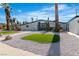 Landscaped front yard with green patches, desert plants and palm trees at 3647 Ottawa Cir, Las Vegas, NV 89169