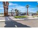 Contemporary home featuring desert landscaping with a circular driveway and palm trees set against a blue sky at 3647 Ottawa Cir, Las Vegas, NV 89169