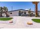 Stylish single-story home with a unique desert landscape and a modern exterior design at 3647 Ottawa Cir, Las Vegas, NV 89169