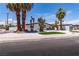 Single story home with desert landscaping, palm trees, and a two-car garage at 3647 Ottawa Cir, Las Vegas, NV 89169