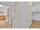 Bright hallway featuring modern flooring and doors leading to an updated bathroom and laundry room at 3647 Ottawa Cir, Las Vegas, NV 89169