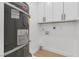Small laundry room with white cabinets and a water heater at 3647 Ottawa Cir, Las Vegas, NV 89169