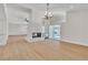 Bright open floor plan featuring fireplace, modern lighting, and pool views at 3647 Ottawa Cir, Las Vegas, NV 89169