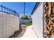 Pathway along house exterior to artificial grass and plants at 3647 Ottawa Cir, Las Vegas, NV 89169