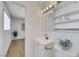 Clean bathroom features modern vanity and fixtures, a decorative plant, and convenient storage shelves at 415 Emerald Cir, Henderson, NV 89002