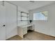Bright bedroom with a built-in desk, shelves, and wood-look flooring at 415 Emerald Cir, Henderson, NV 89002