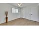 Bright bedroom with wood-look flooring, neutral walls, ceiling fan and closet with sliding doors at 415 Emerald Cir, Henderson, NV 89002