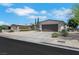 Inviting single-story home featuring a spacious driveway, two-car garage, and xeriscaped front yard at 415 Emerald Cir, Henderson, NV 89002