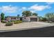 Charming single-story home with a two-car garage, well-kept landscaping, and a sunny sky at 415 Emerald Cir, Henderson, NV 89002