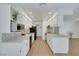 Bright, updated kitchen with white cabinets, countertops, stainless appliances, and backsplash at 415 Emerald Cir, Henderson, NV 89002