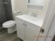 Bathroom features a gray-tiled shower, new vinyl flooring, toilet and new vanity at 4382 Pinegrove St, Las Vegas, NV 89147