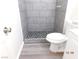 Modern bathroom includes a gray-tiled shower and new vinyl flooring at 4382 Pinegrove St, Las Vegas, NV 89147