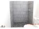 Modern bathroom includes a stand-up shower with gray tiled walls and unique mosaic floor at 4382 Pinegrove St, Las Vegas, NV 89147