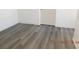 Bright bedroom featuring modern wood-look floors and white trim at 4382 Pinegrove St, Las Vegas, NV 89147