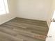 Cozy bedroom featuring grey laminate flooring, white walls, and natural light; perfect for relaxation at 4382 Pinegrove St, Las Vegas, NV 89147