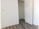 A bedroom featuring gray wood flooring, light walls, and an open closet at 4382 Pinegrove St, Las Vegas, NV 89147